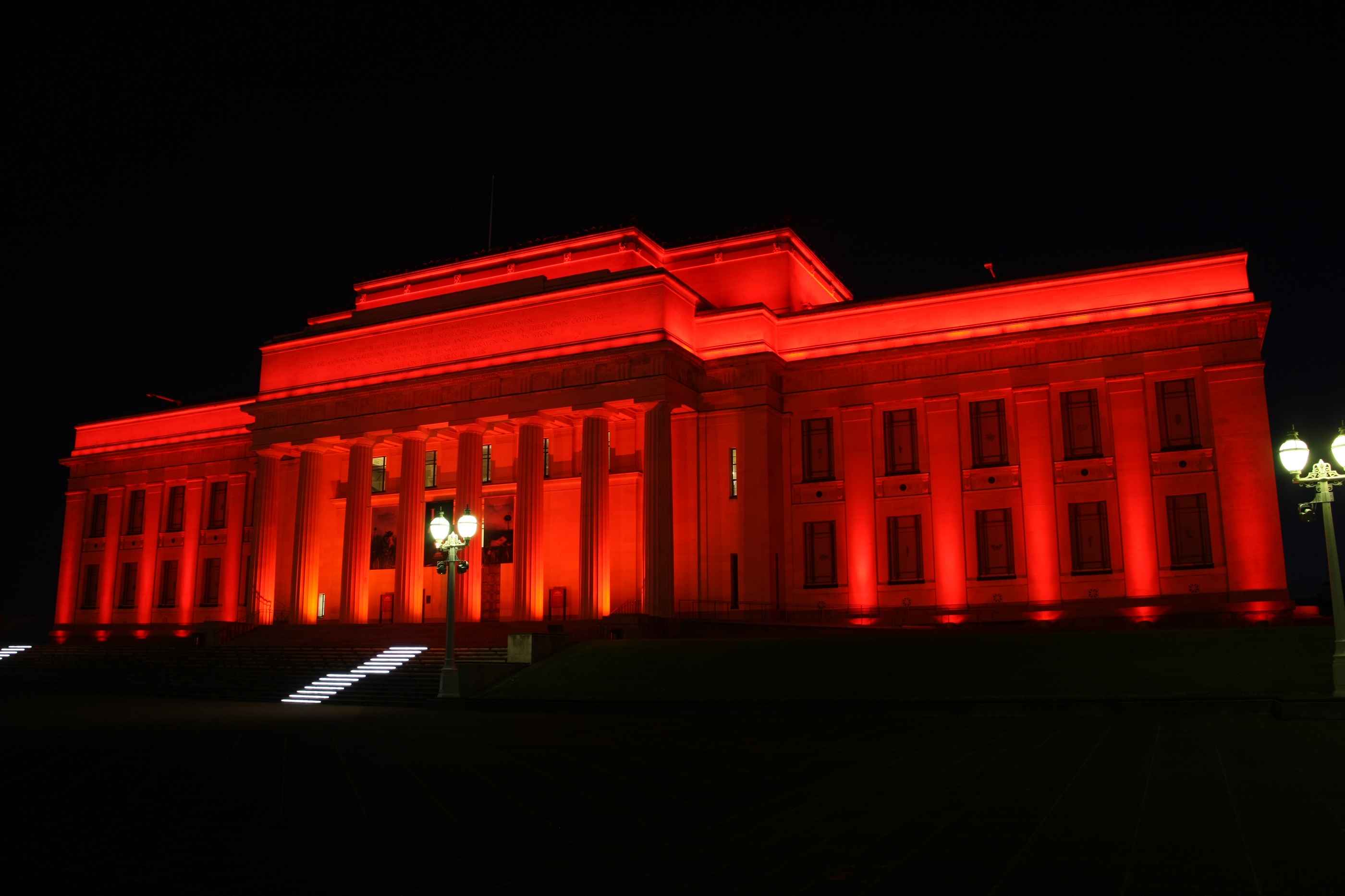 Auckland Museum glowing red for Anzac Day