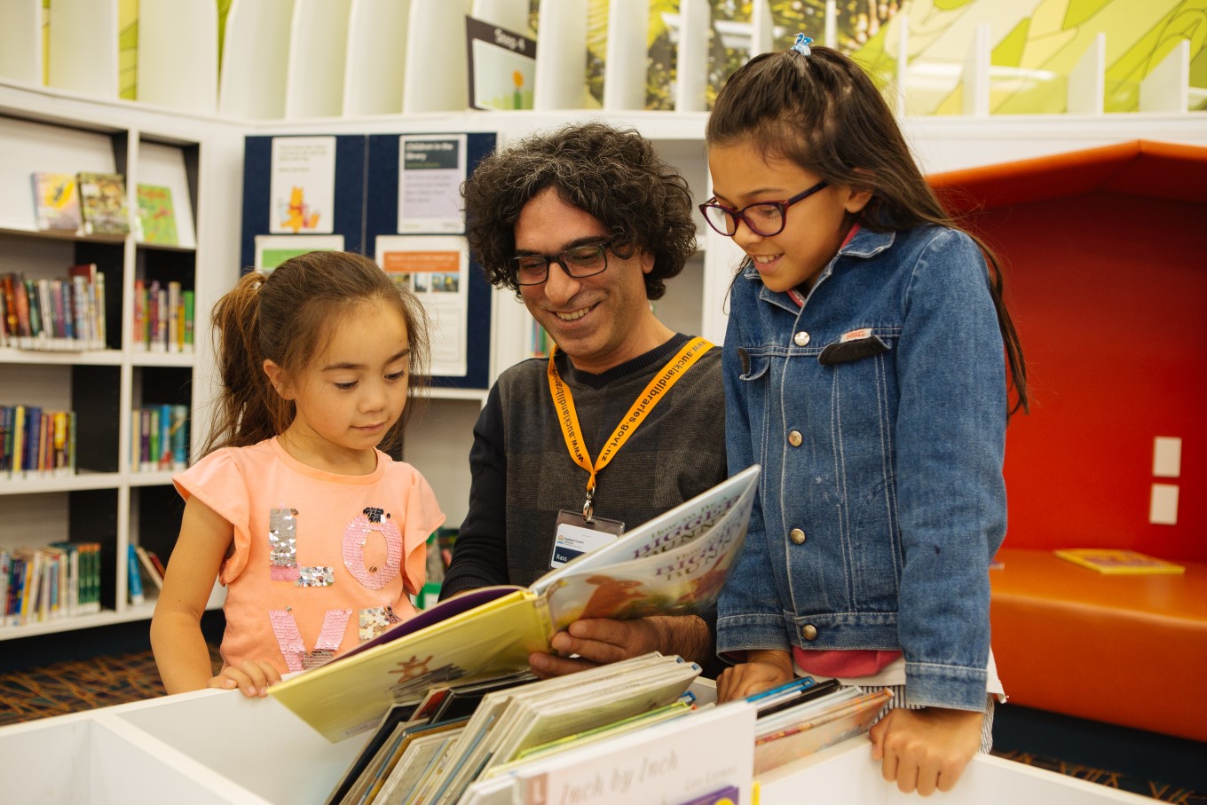 Man and two young girls at libraries.