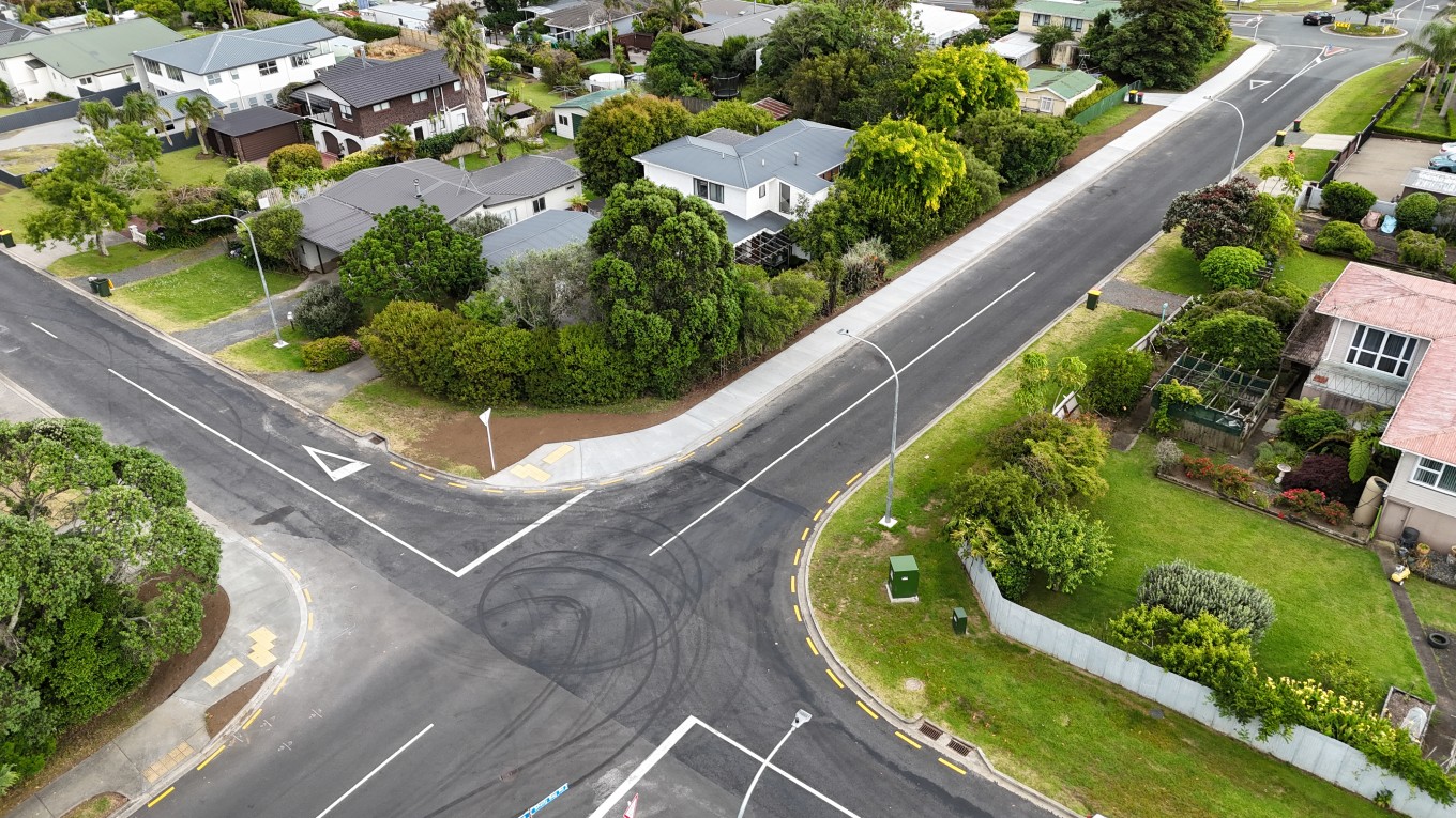 Aerial of intersection in a residential area with newly constructed footpath.