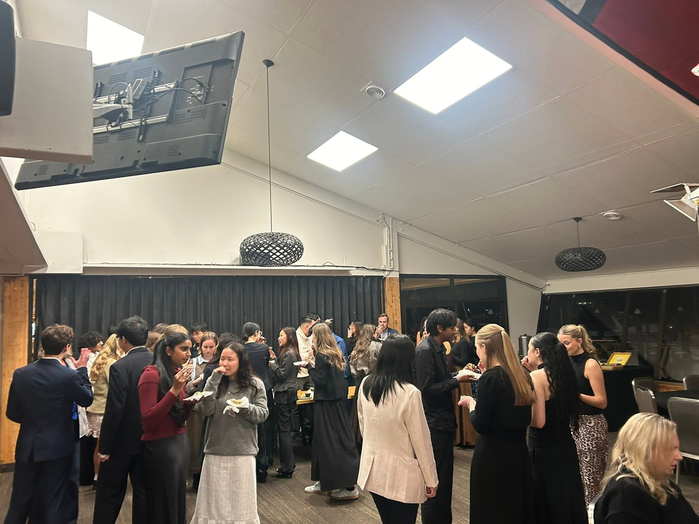 Young people socialising in a group event at a community function. 