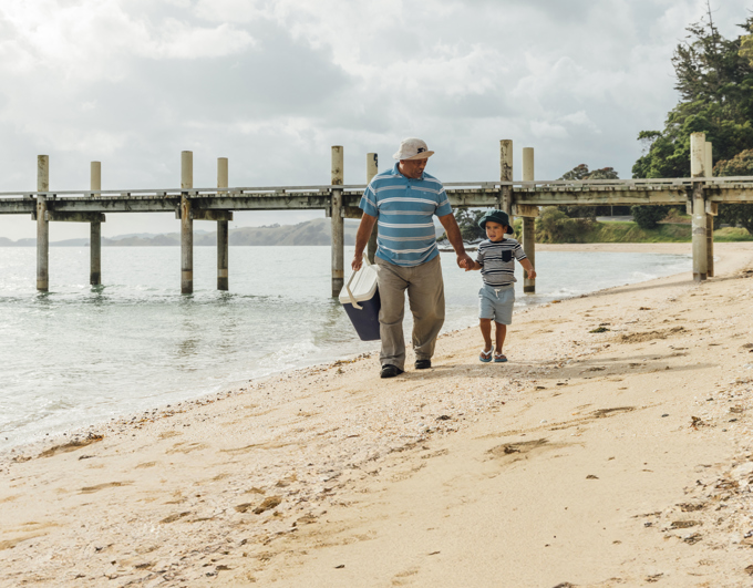 Rep Review Magazine Bay Dad And Son Walking On Beach Cropped