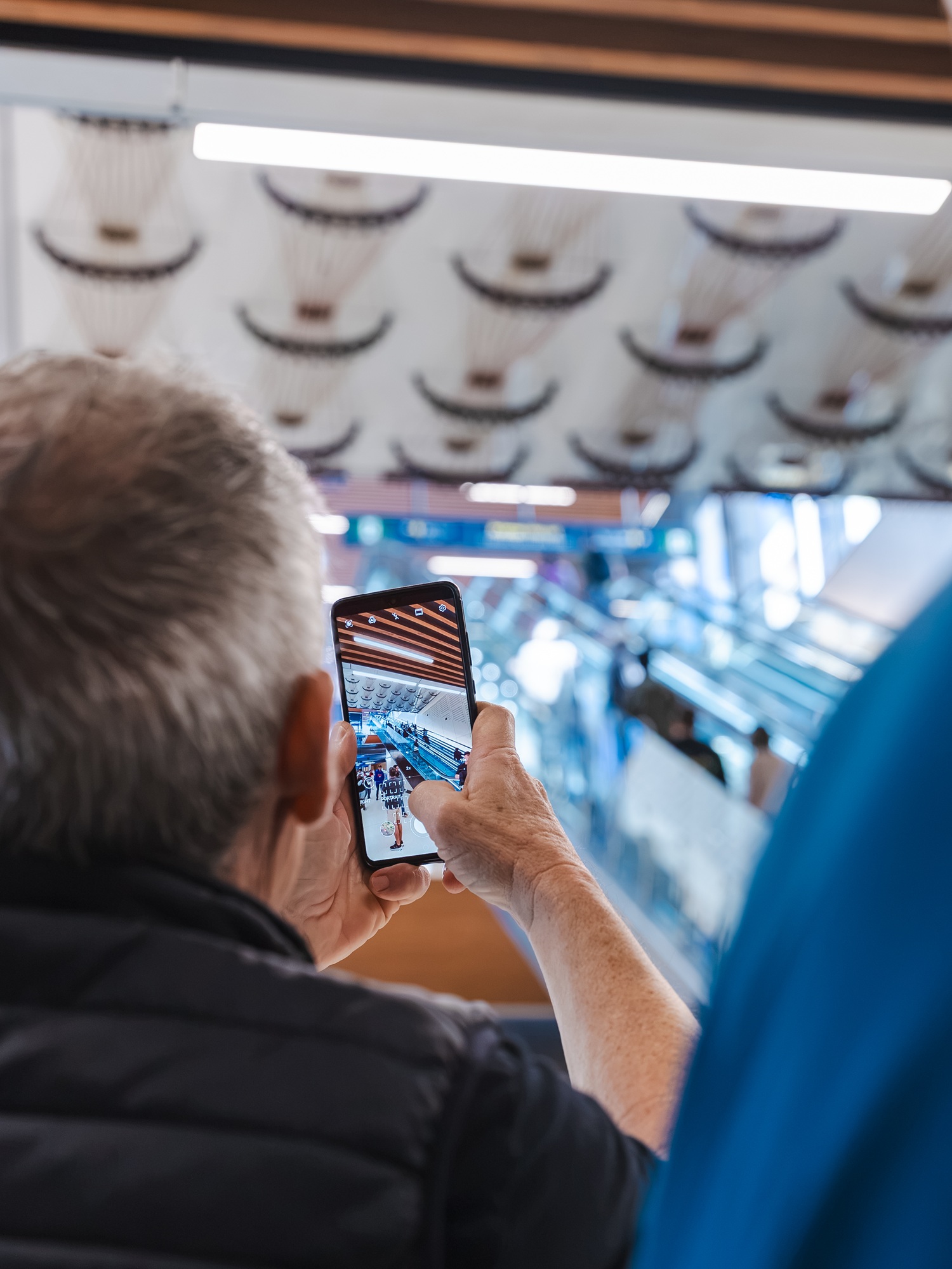 A man taking a photo on a smartphone. 