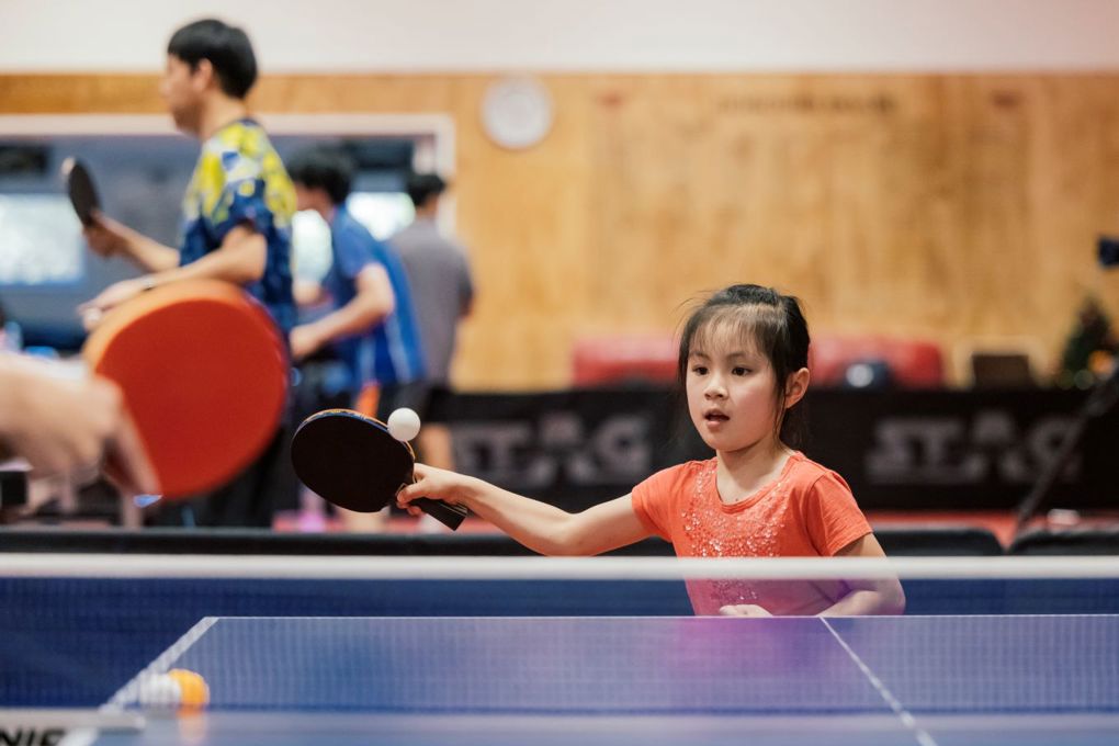 Young child playing table tennis