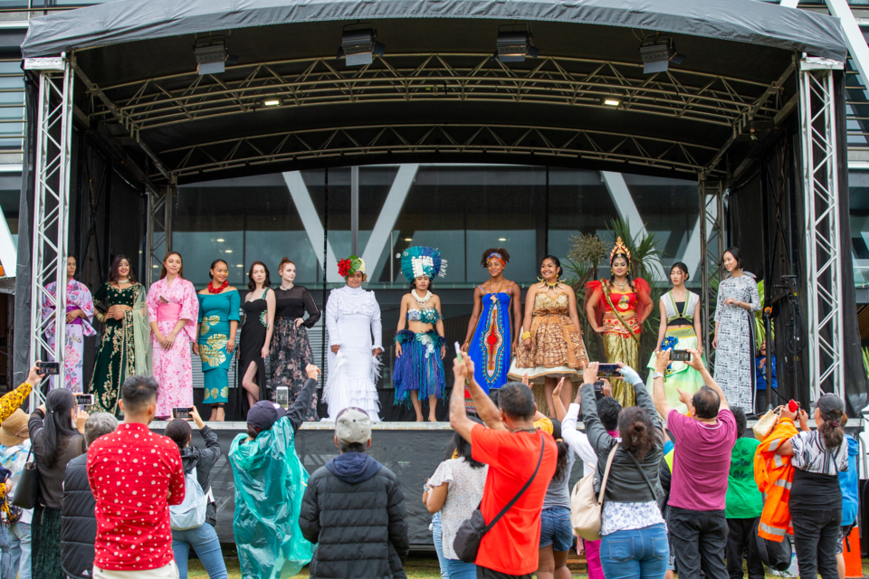 An array of cultures represented by a line up of ladies in traditional costume on stage at Tāmaki Makaurau's Diversity Festival 2020