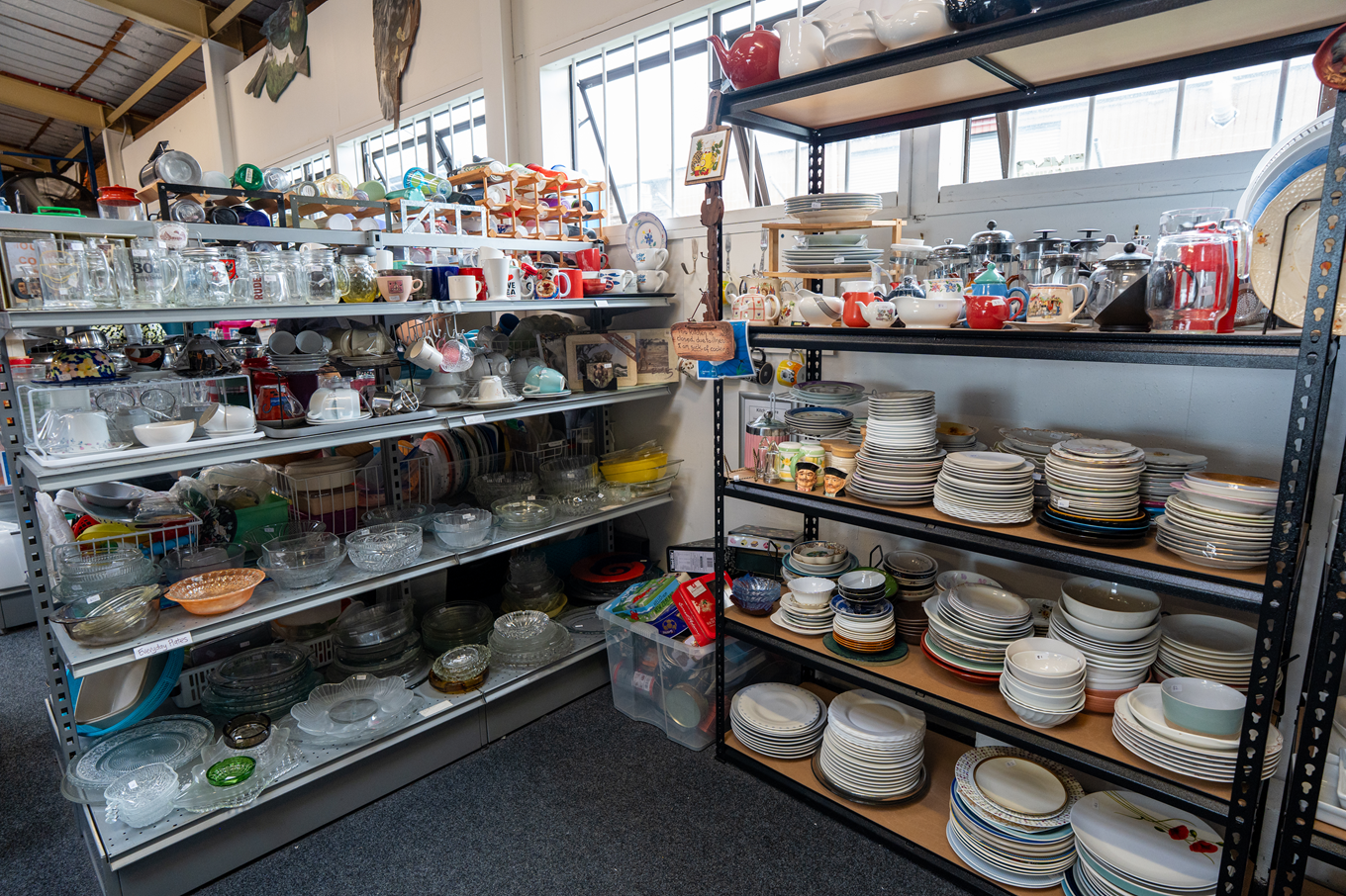 A collection of kitchen equipment on display at a community recycling centre.