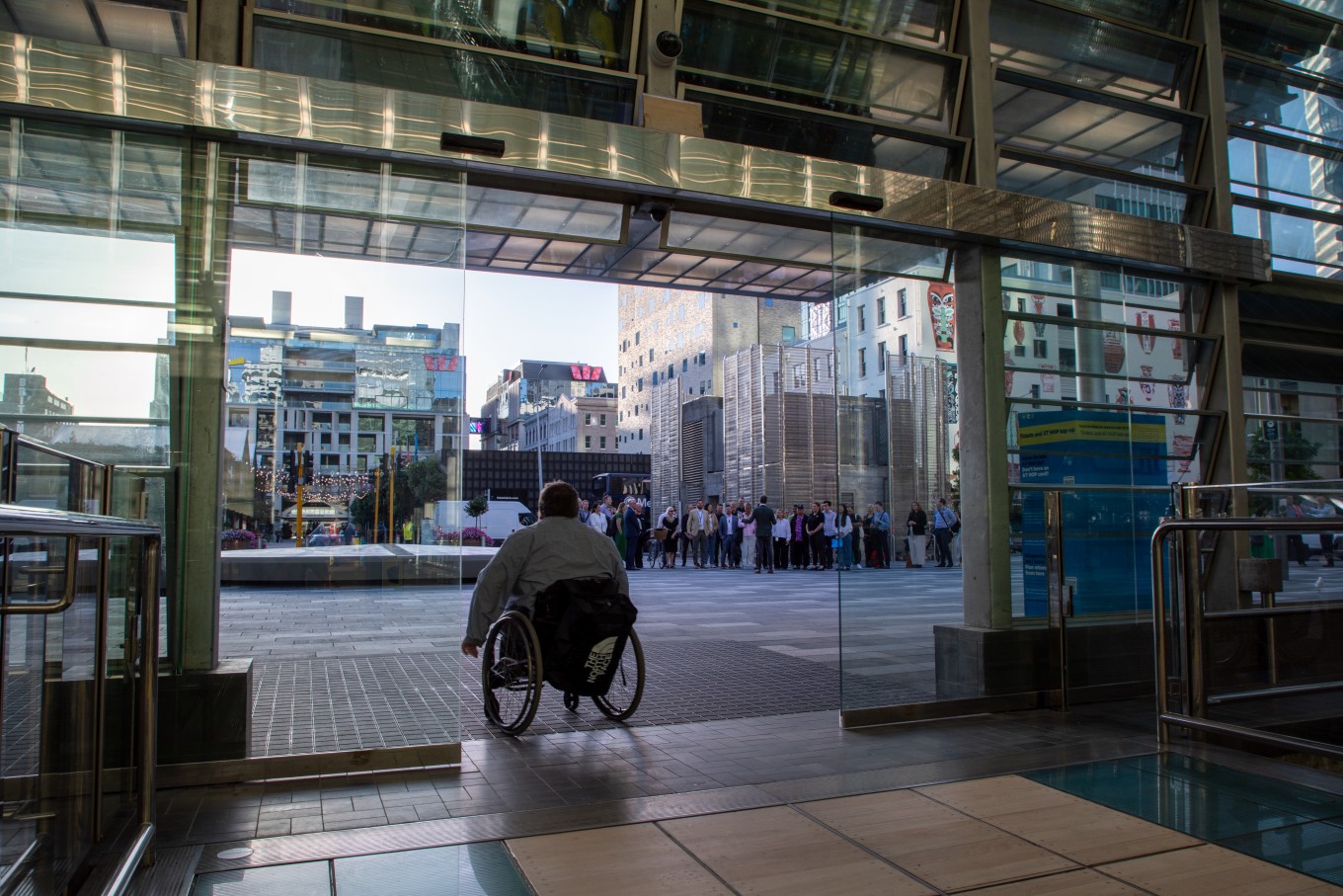 A person on a wheel chair leaving Waitematā Station. 