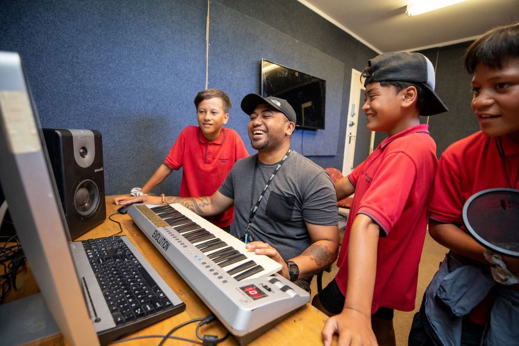 School kids at recording studio with local music producer