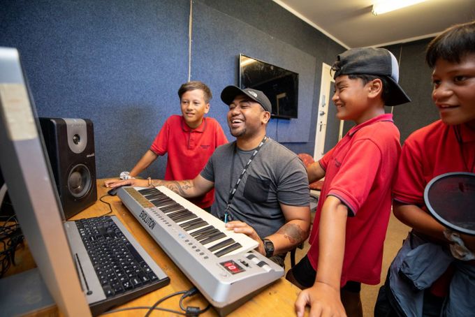 School kids at recording studio with local music producer