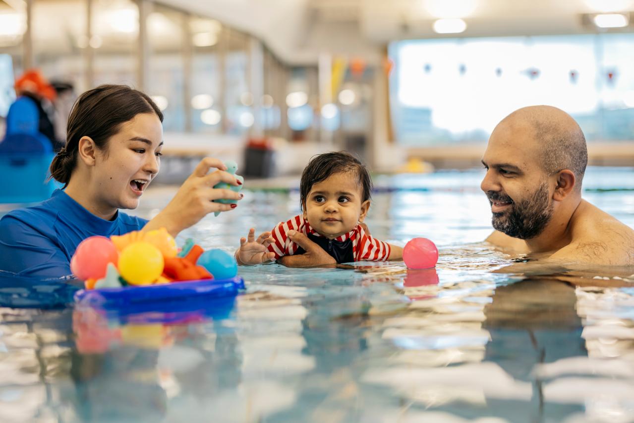 People learning to swim at a community pool.