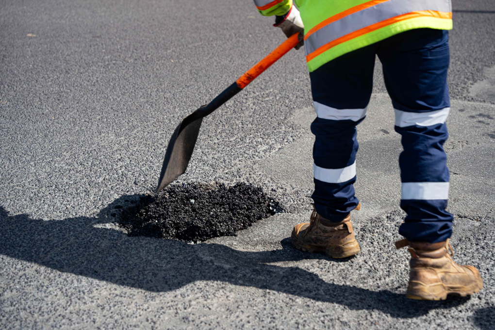 Workman Fixing A Pothole