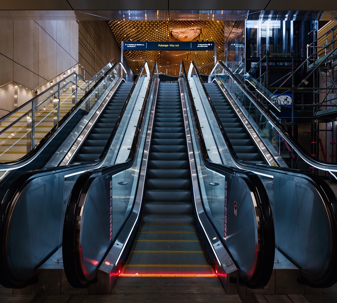 A set of escalators at a train station.