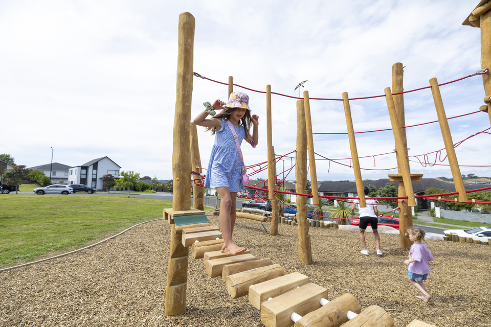 Ōrewa playground with a little girl playing on it. 