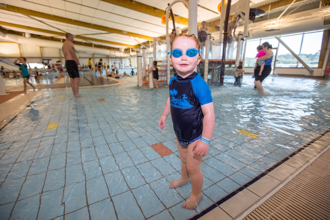 Toddler with googles on in pool. 