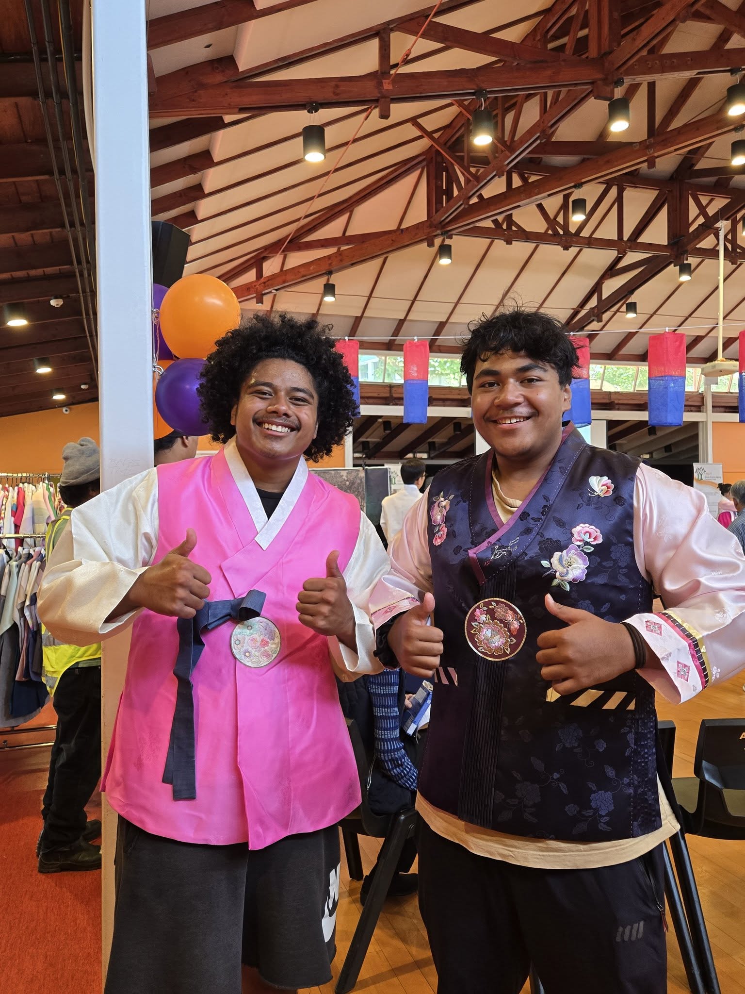 Two people in Korean attire for a community festival. 