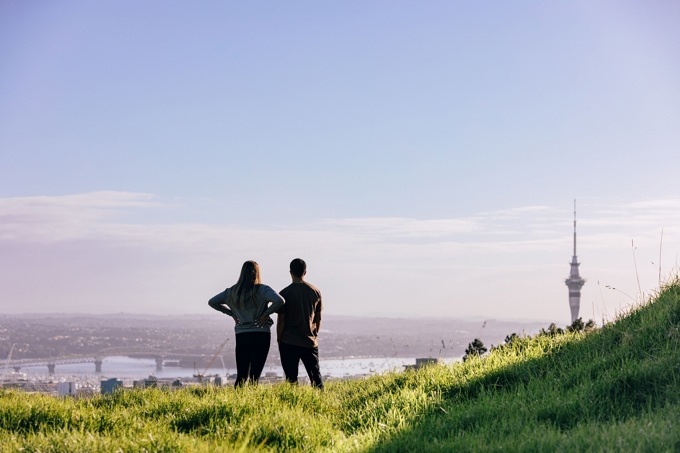 Couple Admire View Of City From Summit