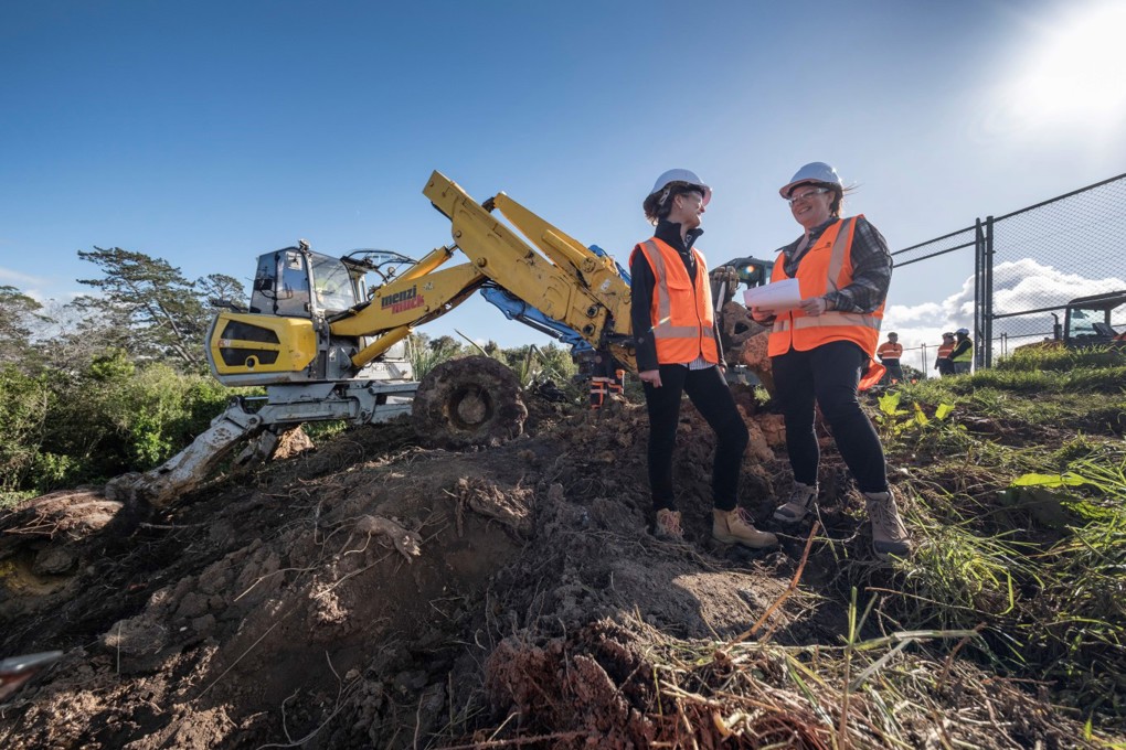 Watercare Project Manager Monica Paterson And Flood Recovery Manager Suzanne Lucas With The Spider Digger At A Birkenhead Slip Resized