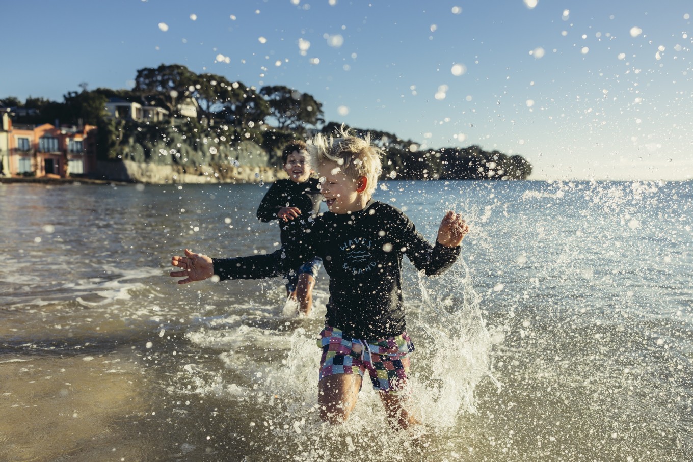 Kids running in the water. 