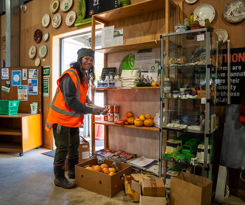 A volunteer placing items on the shelf. 