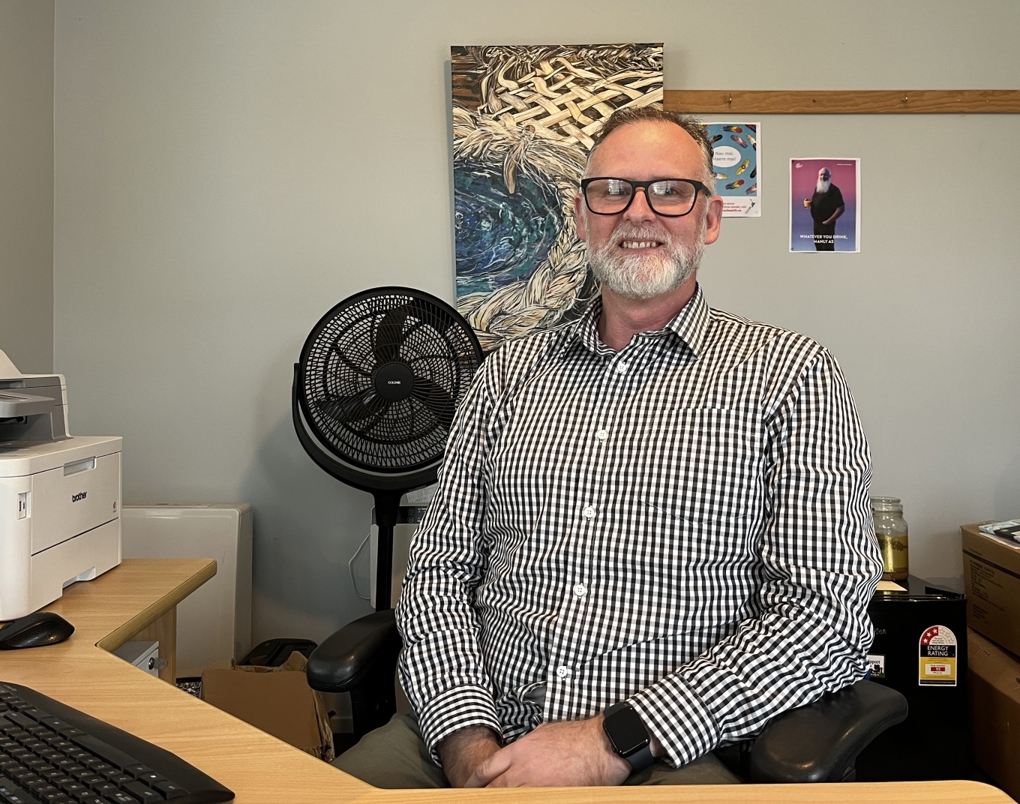 A man sitting at his desk in an office