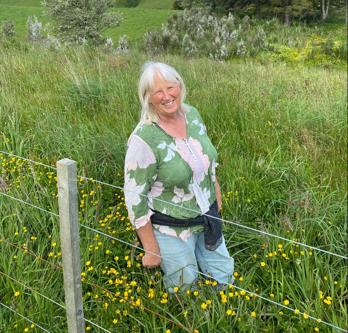 A lady standing in a field. 
