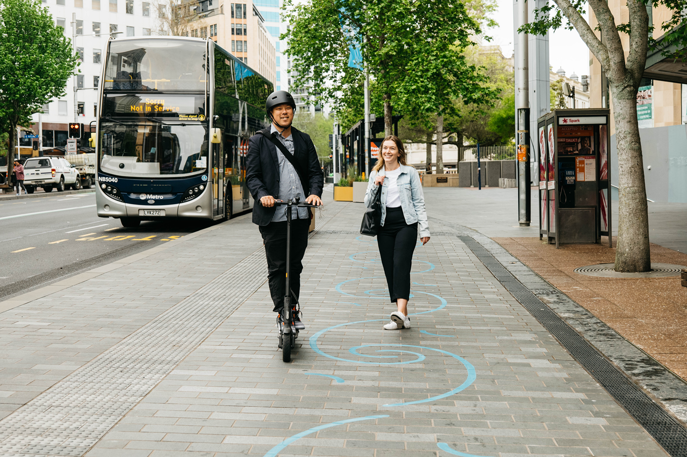 A person riding a e-scooter in the Auckland City Centre. 