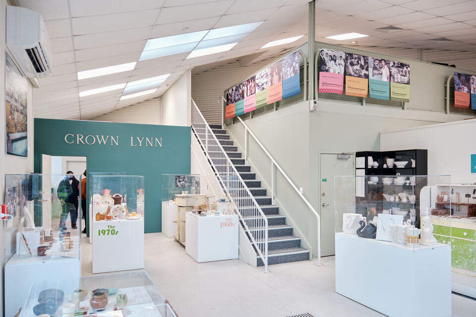 People walking through the Crown Lynn museum showcasing historically significant kitchenware.