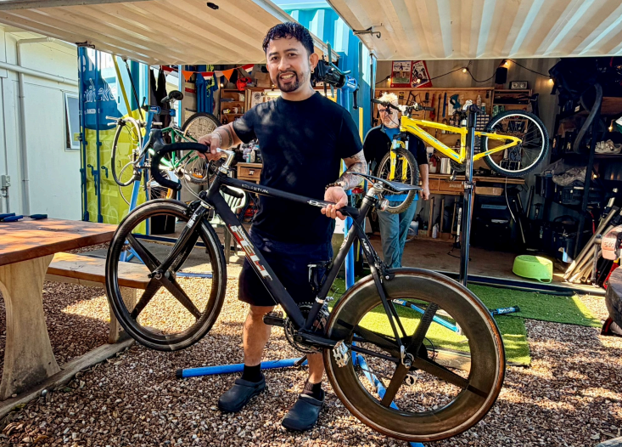 A man fixing a bike at a bike hub.