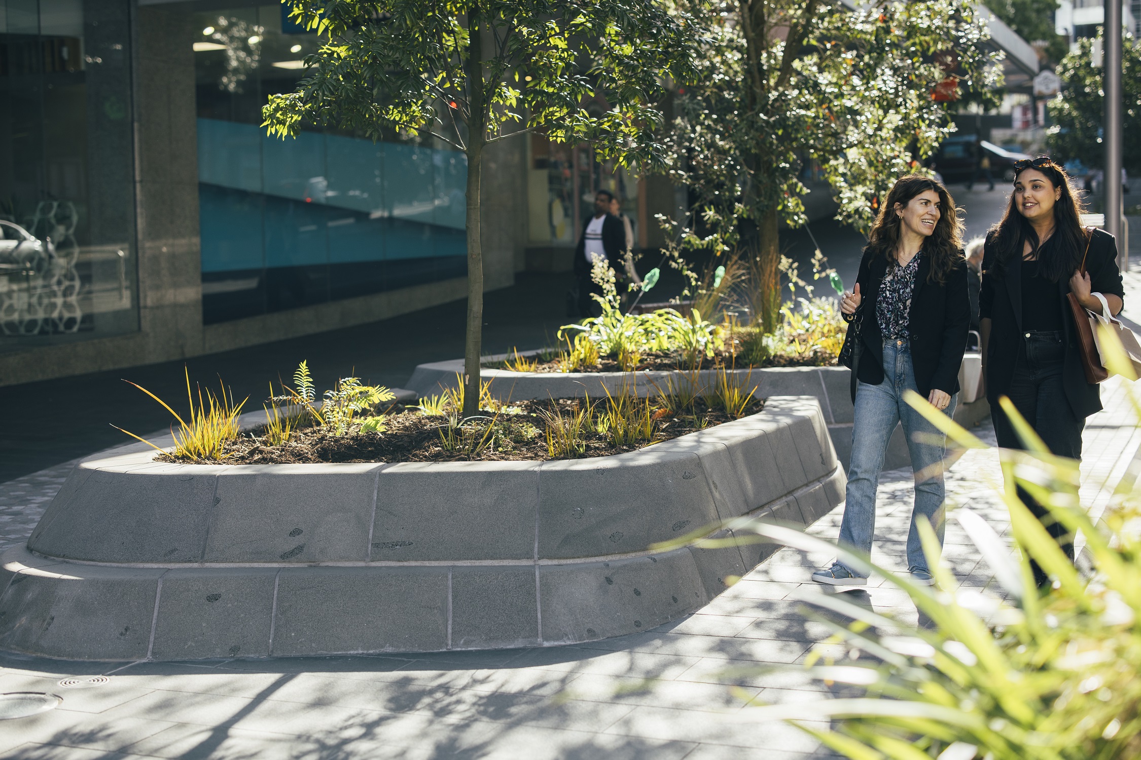 Two women walking by Te Ha Noa. 