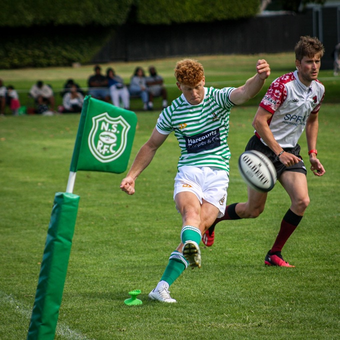 Rugby player kicking the ball