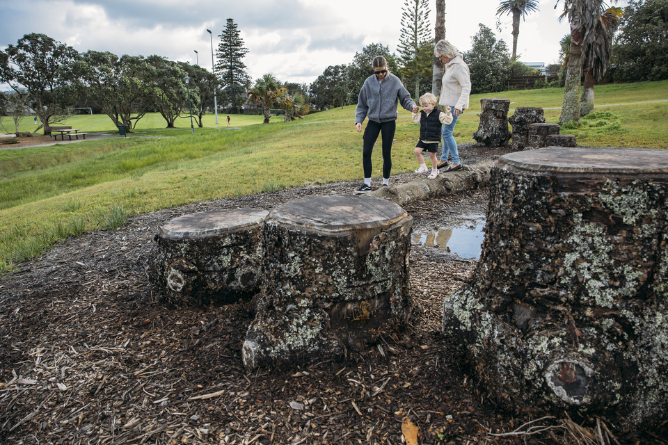 Families out playing at the park. 
