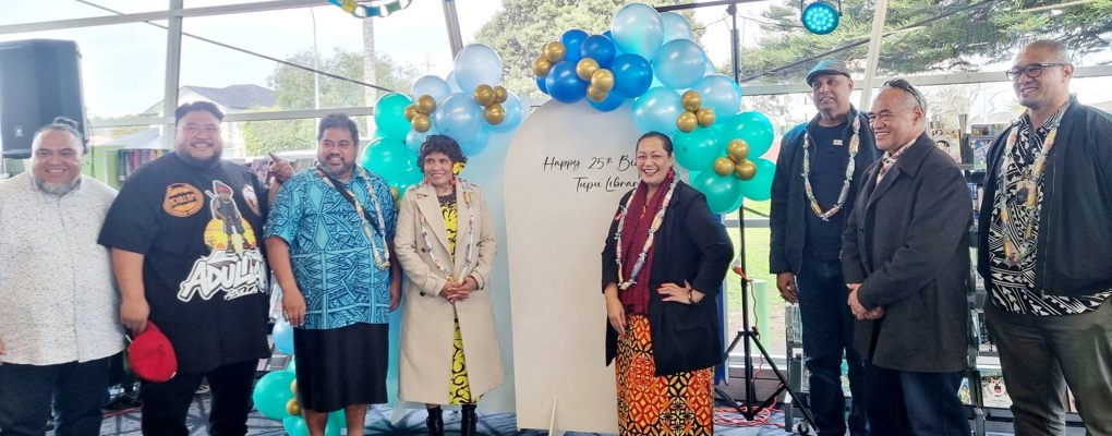 A group of workers celebrating 25 years of working at the community library