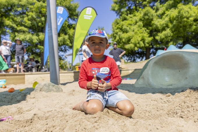 A kid playing in the sand