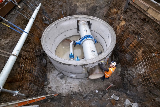 Ground Crew Stands Next To The Line Valve Chamber