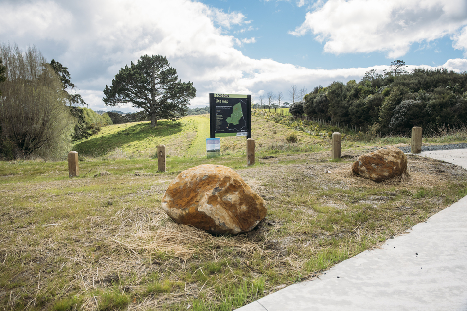 Two rocks by a Auckland Council sign. 