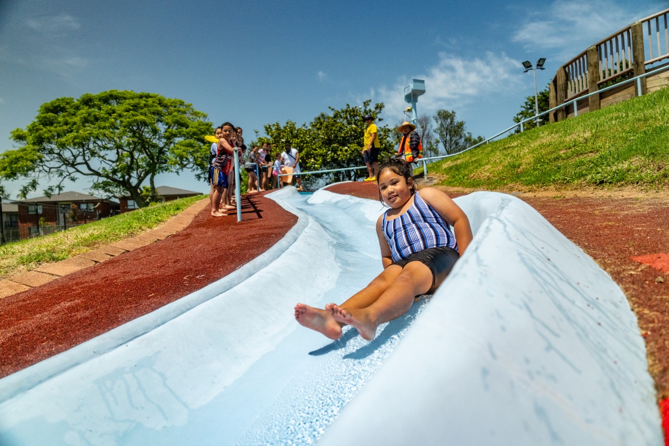 Young girl going down the waterslide. 