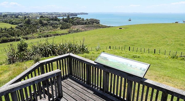 A boardwalk at the top of a hillside. 