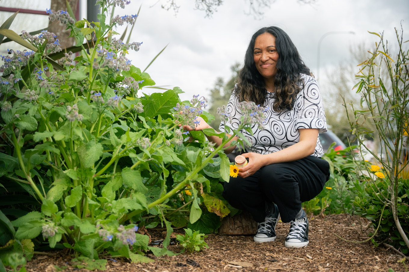 A woman planting native plants. 