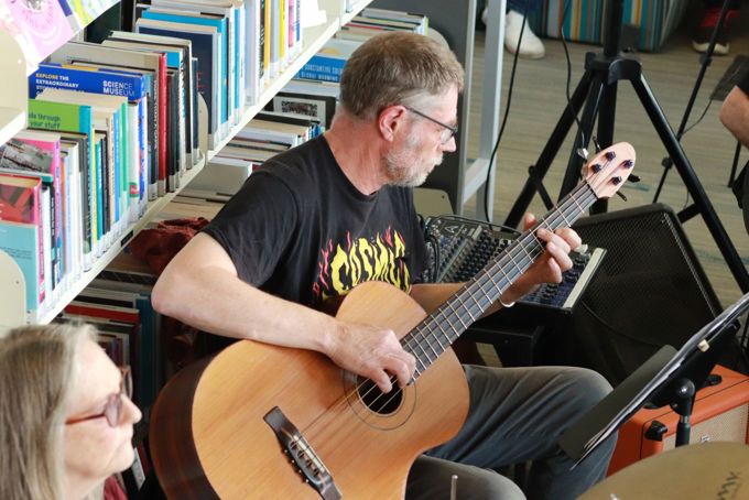 A guy playing a guitar