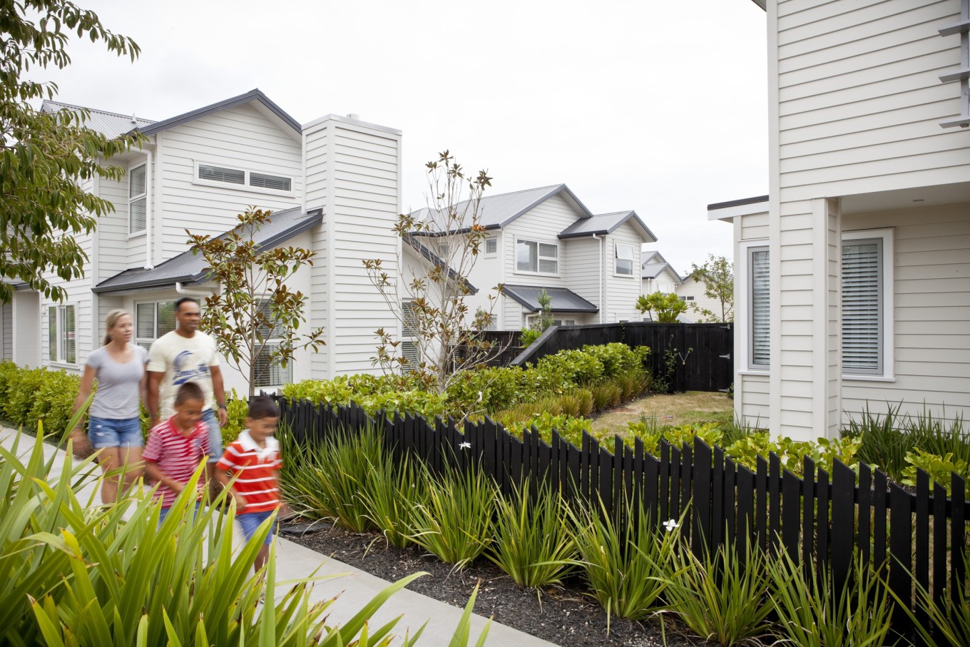A family walking through Hobsonville Point neighbourhood. 
