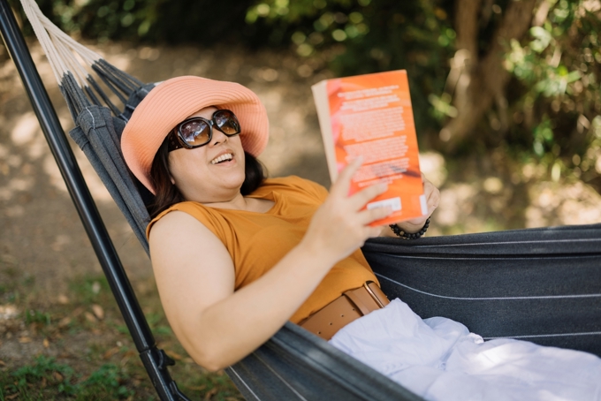 A lady reading a book in the hammock