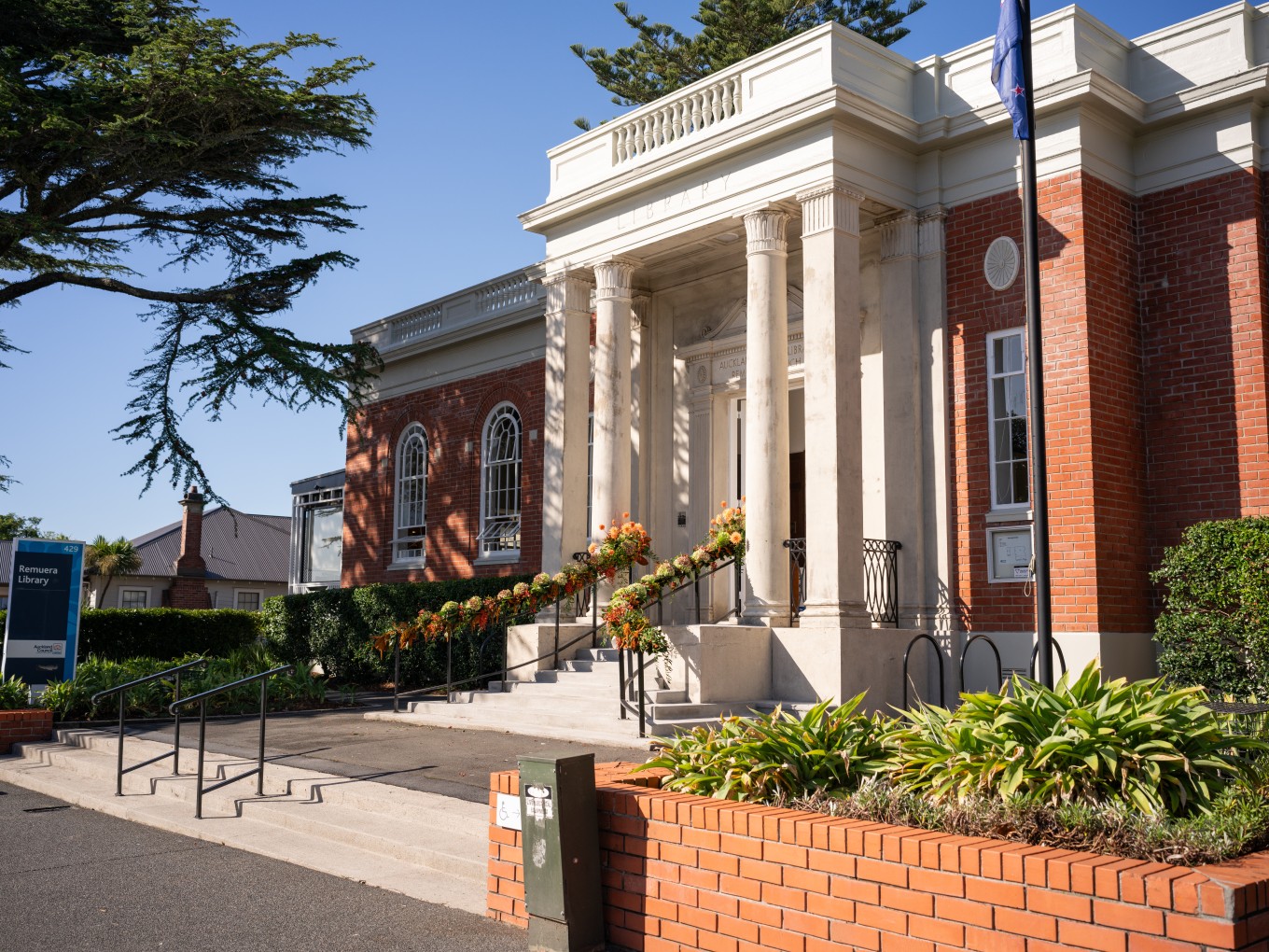 A large brick building with white pillars near the front entrance