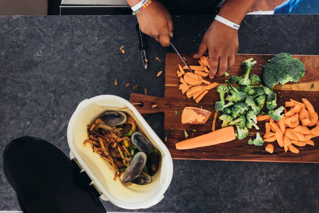 A person cutting vegetables on a chopping board