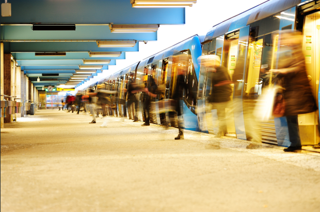 People exiting a train onto a platform