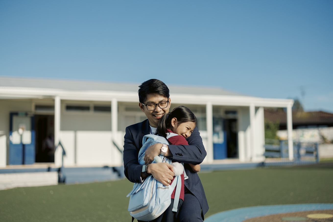 A man hugging a little girl. 