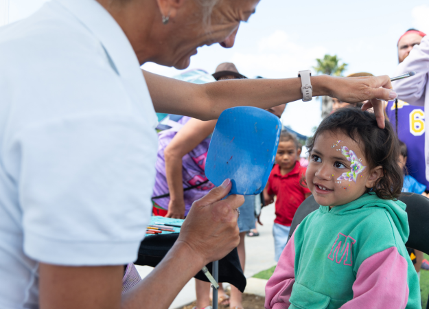 Child getting face paint.