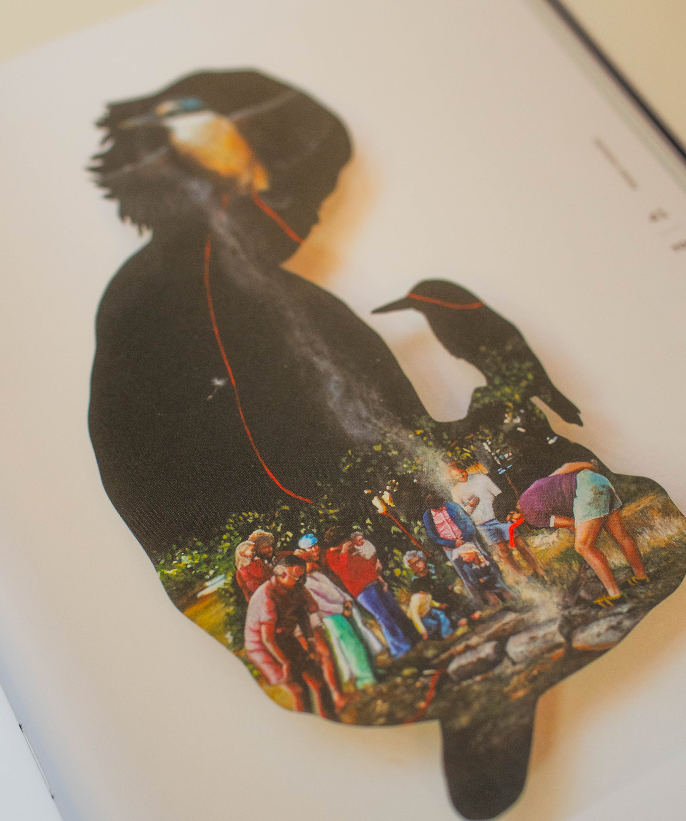 An artwork of a girl's shadow with people celebrating inside her shadow. 