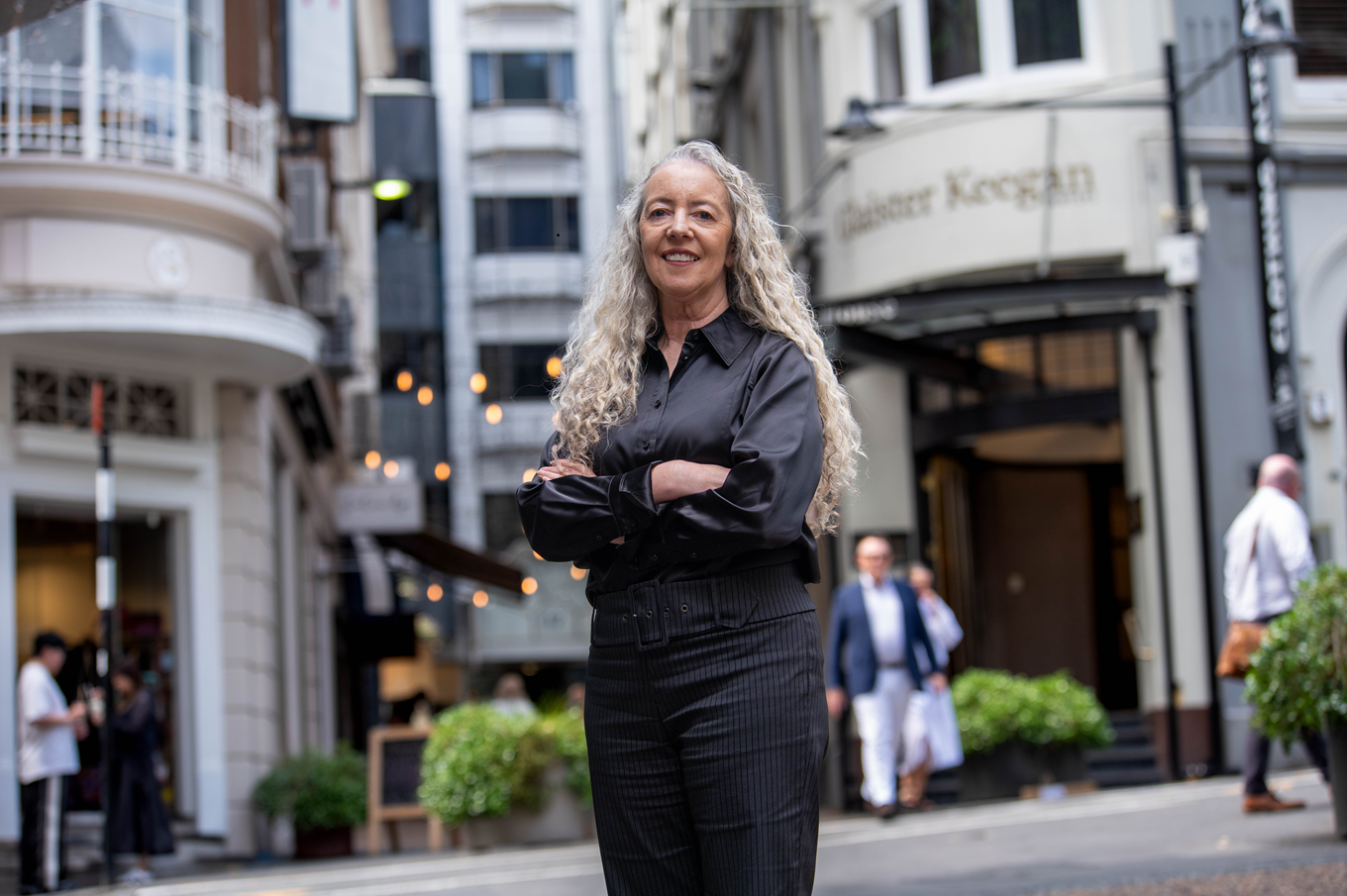 A woman standing in a side street in the city centre.