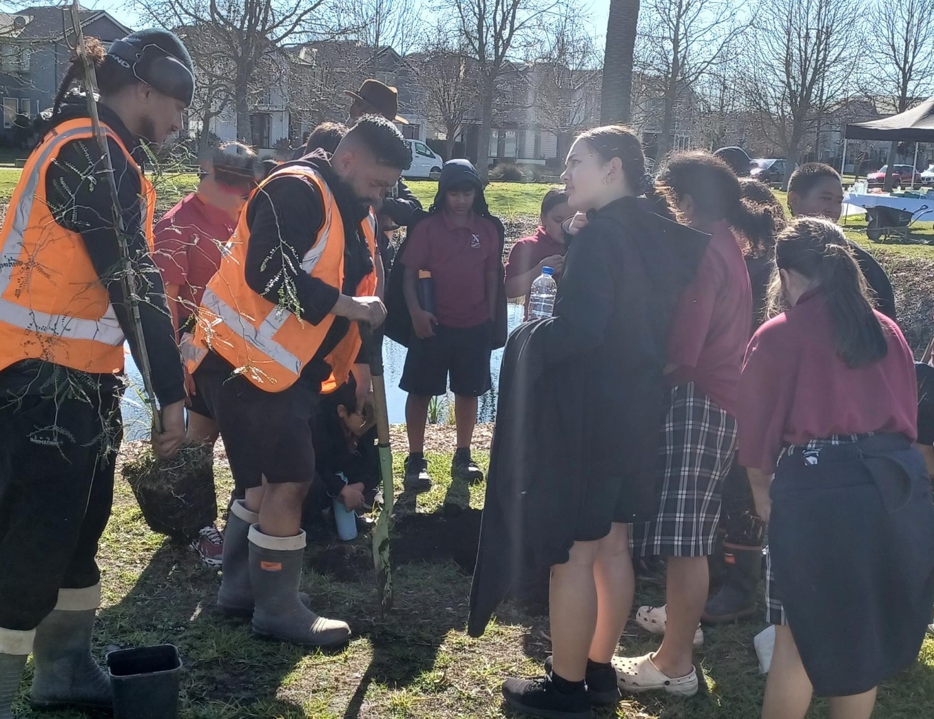 Papakura Primary School students preparing to plant a kowhai tree.