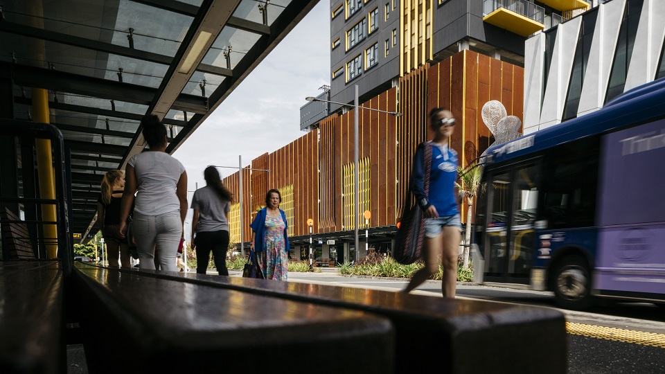 People walking around the New Lynn travel hub.