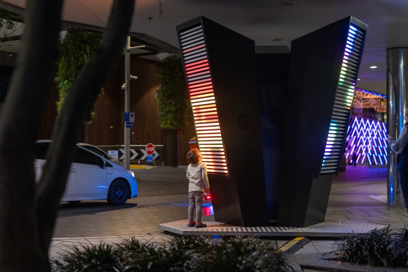 A kid looking at winter lights.